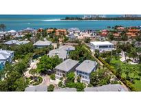 Stunning aerial view showcasing luxurious beachfront homes and the sparkling ocean coastline at 3959 Somerset Dr # 5, Sarasota, FL 34242