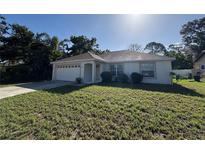 Charming single-story home with a well-maintained lawn and attached two-car garage at 4031 Wake Ave, Sarasota, FL 34241