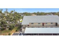 Exterior view of condo building featuring covered parking, and a well maintained landscaped yard at 516 Parkdale Mews # 516, Venice, FL 34285