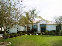Charming single-story home with manicured lawn, lush landscaping, and attached garage at 5449 Downham Mdws, Sarasota, FL 34235