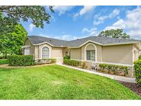 Attractive home with a well-manicured lawn and lush landscaping at 6908 Stoneywalk Ct, Bradenton, FL 34203