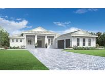 Stunning single-story home features a paver driveway, lush landscaping and a welcoming front porch at 8045 Nevis Run, Bradenton, FL 34202