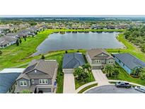 Beautiful aerial view of homes and a scenic lake in a well-maintained, vibrant community at 10609 Great Cormorant Dr, Riverview, FL 33579
