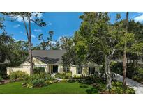 Charming home featuring lush landscaping, a well-manicured lawn, and a welcoming entrance at 140 Sugar Mill Dr, Osprey, FL 34229