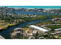 Stunning aerial view showcasing the waterfront property, lush greenery, and beautiful coastal surroundings at 1921 Monte Carlo Dr # 302, Sarasota, FL 34231