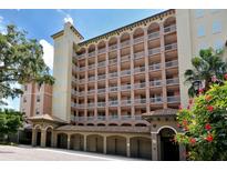 Beautiful multi-story condo building featuring private balconies and covered parking, set in a lush, tropical landscape at 1921 Monte Carlo Dr # 302, Sarasota, FL 34231