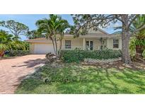 Charming single-Gathering home with a well-manicured lawn and a red brick driveway at 205 Sugarloaf Dr, Nokomis, FL 34275