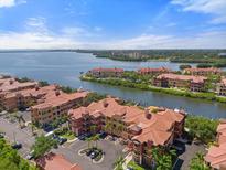 Beautiful aerial view of waterfront condos with terracotta roofs, lush landscaping, and stunning water views at 2741 Via Cipriani # 935A, Clearwater, FL 33764
