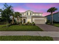 Charming two-story home with a manicured lawn, inviting entrance, and attached two-car garage at 3344 Anchor Bay Trl, Bradenton, FL 34211