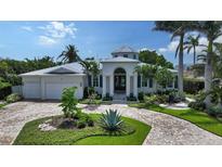 Beautiful home with lush landscaping, a circular driveway, and a stately front entrance at 413 Partridge Cir, Sarasota, FL 34236