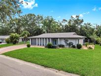Charming single-story home with a well-manicured lawn and inviting curb appeal at 4455 Emerald Ridge Dr, Sarasota, FL 34233