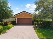 Inviting home featuring a brick driveway and a well-manicured lawn at 5121 Serata Dr, Lakewood Ranch, FL 34211