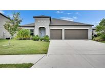 Charming single-story home with a well-manicured lawn and a two-car garage at 5521 Olano St, Palmetto, FL 34221
