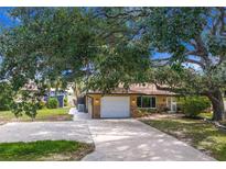 Charming single-story home with a well-manicured lawn and long concrete driveway at 760 Azure Rd, Venice, FL 34293