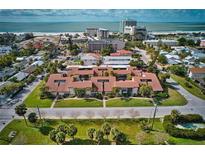 Stunning aerial view of condos with red tile roofs near the ocean, showcasing the community and its proximity to the beach at 800 S Blvd Of The Presidents # 16, Sarasota, FL 34236