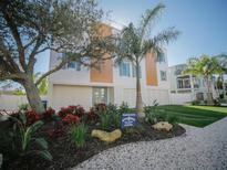 Beautiful coastal home featuring a landscaped front yard, modern design, and a welcoming beach vibe at 111 6Th N St, Bradenton Beach, FL 34217