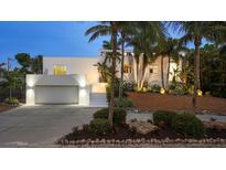 Beautiful home with lush landscaping and a well-lit garage and stairway leading to the entrance at 1168 Westway Dr, Sarasota, FL 34236