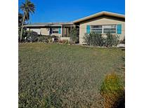 Charming home with large front yard and eye-catching blue shutters at 134 Gulfview Rd, Punta Gorda, FL 33950