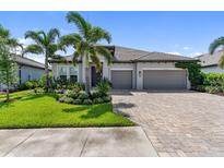 Beautiful single-story home featuring a well manicured lawn, lovely landscaping and two-car garage at 17737 Savory Mist Cir, Bradenton, FL 34211