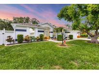 Charming single-story home with manicured lawn, mature trees, and attractive landscaping at 2381 Appaloosa Cir, Sarasota, FL 34240