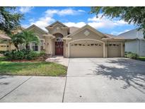Charming single-story home featuring a three-car garage and lush landscaping in a desirable location at 3041 Stonegate Falls Dr, Land O Lakes, FL 34638