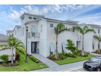 Beautiful three-story home with modern architectural details and lush tropical landscaping at 6028 Red Mangrove Ln, Bradenton, FL 34210