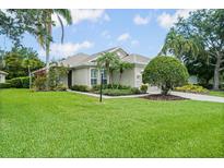 Charming single-story home with lush green lawn, mature landscaping, and a well-manicured front yard at 7424 Sea Island Ln, Bradenton, FL 34201