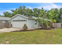 Charming single-story home featuring a two-car garage, well-maintained lawn, and mature landscaping at 2218 Woodmere Rd, Venice, FL 34293