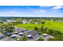 Scenic aerial view of townhomes with carports and green space for a relaxing community atmosphere at 2915 29Th W Ave, Bradenton, FL 34205
