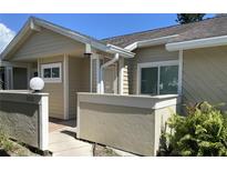 Inviting front entrance with beige siding and brick accents, creating a warm and welcoming atmosphere at 3032 Heron Lake Ct # 7B, Venice, FL 34293