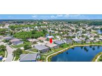 Beautiful aerial view of a property on the lake with a screen enclosed pool and well maintained landscaping at 4531 Useppa Dr, Bradenton, FL 34203
