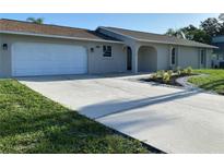 Charming home with a new driveway and updated landscaping with palm trees at 481 Saturn Ave, Sarasota, FL 34243