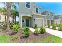 Charming two-story home with a well-manicured lawn, attached garage, and a welcoming front entrance at 5711 Archipelago St, Nokomis, FL 34275