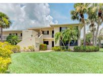 Inviting two-story condo with lush landscaping, mature palms, and manicured lawn at 7110 Fairway Bend Ln # 181, Sarasota, FL 34243