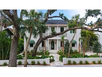 Stunning two-story home featuring lush landscaping, a black balcony, and a charming front entrance at 1658 Bonita Ln, Sarasota, FL 34239