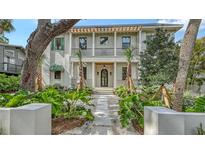 Stunning two-story home featuring manicured landscaping and a grand entrance with beautiful architectural details at 1658 Bonita Ln, Sarasota, FL 34239