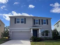 Charming two-story home with a well-manicured lawn, a two-car garage, and beautiful stone accents at 17637 Cantarina Cv, Bradenton, FL 34211