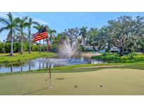 Beautiful Florida home featuring a putting green, pond with fountain, and an American flag waving in the breeze at 5311 36Th E Ave, Palmetto, FL 34221
