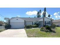 Charming single-story home with a two-car garage, complemented by a well-maintained lawn and attractive landscaping at 620 Camellia Ave, Ellenton, FL 34222