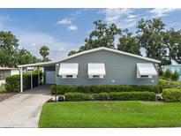 Charming single-story home with covered parking, awning-covered windows, and well-maintained landscaping at 6710 36 E Ave # 114, Palmetto, FL 34221