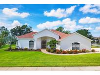 Charming single-story home with a well-manicured lawn and beautiful landscaping at 7133 Dornough Ln, Bradenton, FL 34202