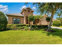 Charming single-Gathering home featuring a meticulously landscaped front yard and a well-maintained lawn at 773 Rosemary Cir, Bradenton, FL 34212