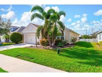 Charming single-story home with manicured lawn, lush landscaping, and a two-car garage at 7750 Ridgelake Cir, Bradenton, FL 34203
