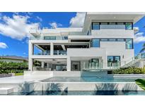 Stunning modern home with a multi-level deck, outdoor kitchen, and beautiful pool overlooking the water at 1610 N Lodge Dr, Sarasota, FL 34239