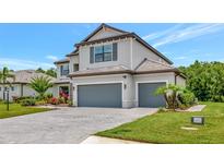 Beautiful two-story home with a three-car garage and professionally landscaped yard at 16231 Tradewind Ter, Bradenton, FL 34211