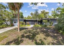 Charming single-story home with mature landscaping and a cozy front porch at 2850 Bon Air Ave, Sarasota, FL 34234