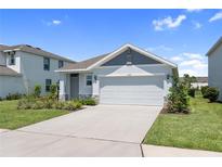 Charming single Gathering home with a well-manicured lawn and two car garage on a sunny day at 3355 Hilltop Cir, Bradenton, FL 34211