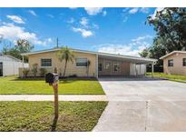 Charming single-story home with a covered carport and well-maintained front lawn at 3641 Stokes Dr, Sarasota, FL 34232