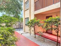 Inviting condo with landscaping, a red walkway, and a private entrance at 3700 S Osprey Ave # 122, Sarasota, FL 34239