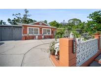 Charming single-story home with a cozy exterior, well-maintained landscaping, and a welcoming front yard at 3957 Proctor Rd, Sarasota, FL 34233